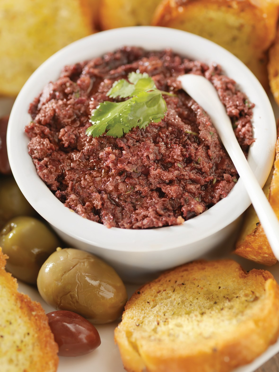 Bruscetta penslet med olivenolje og pesto toppet med tapenade
