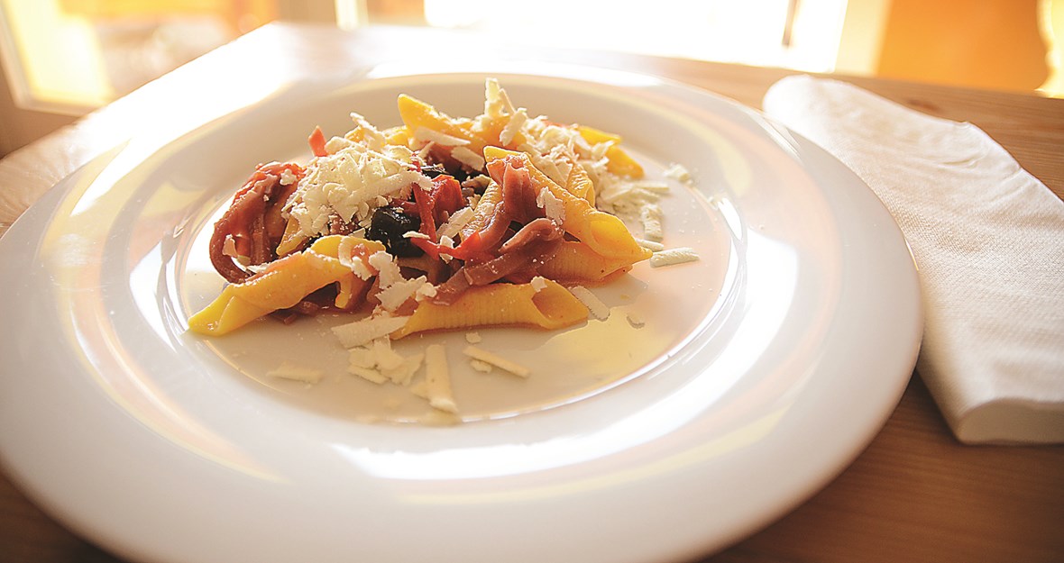 Garganelli Romagnola servert med tomater, tørket skinke, Tagiascca oliven og lagret Riccotta ost